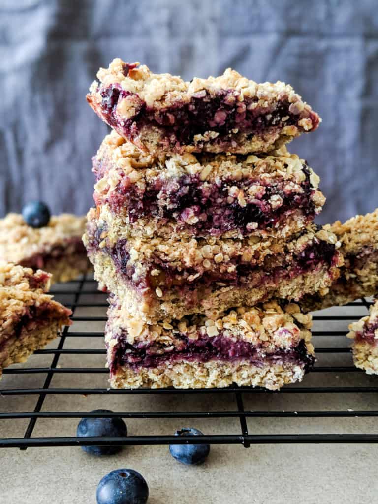 A stack of vegan rhubarb and blueberry crumble bars