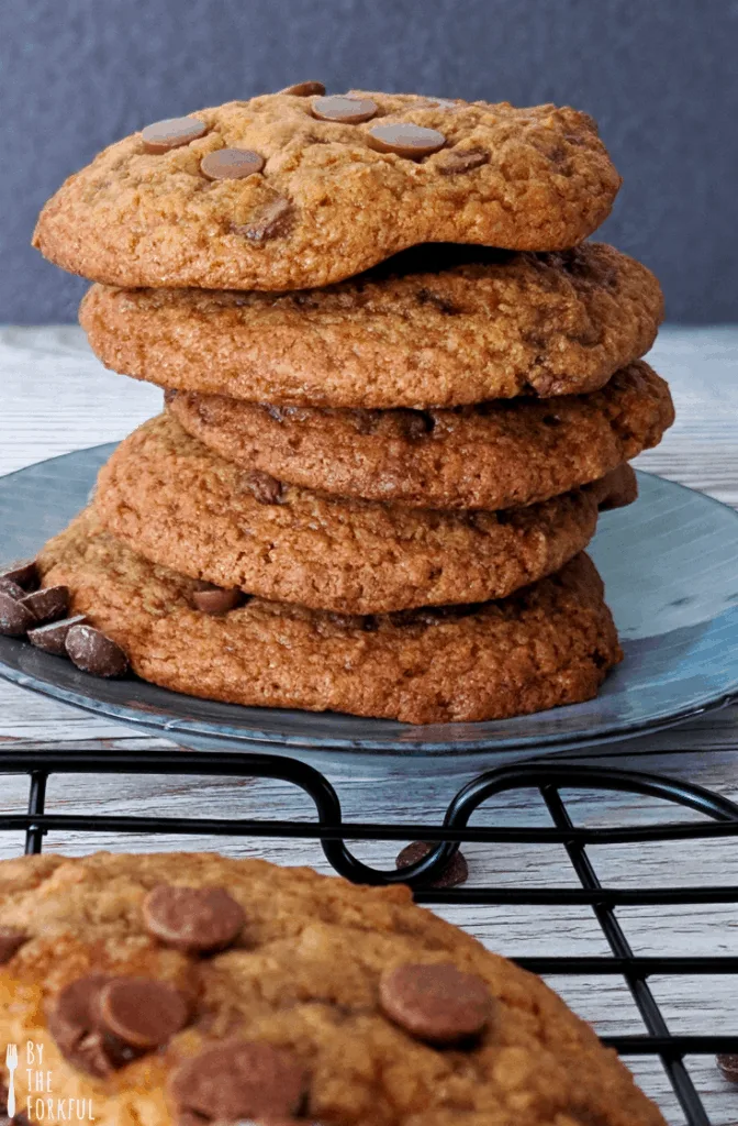 Vegan chocolate chip cookies stacked on a blue plate