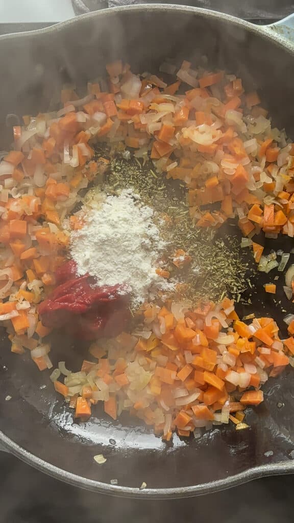tomato paste, plain flour, and seasonings added to sauted onion and carrot