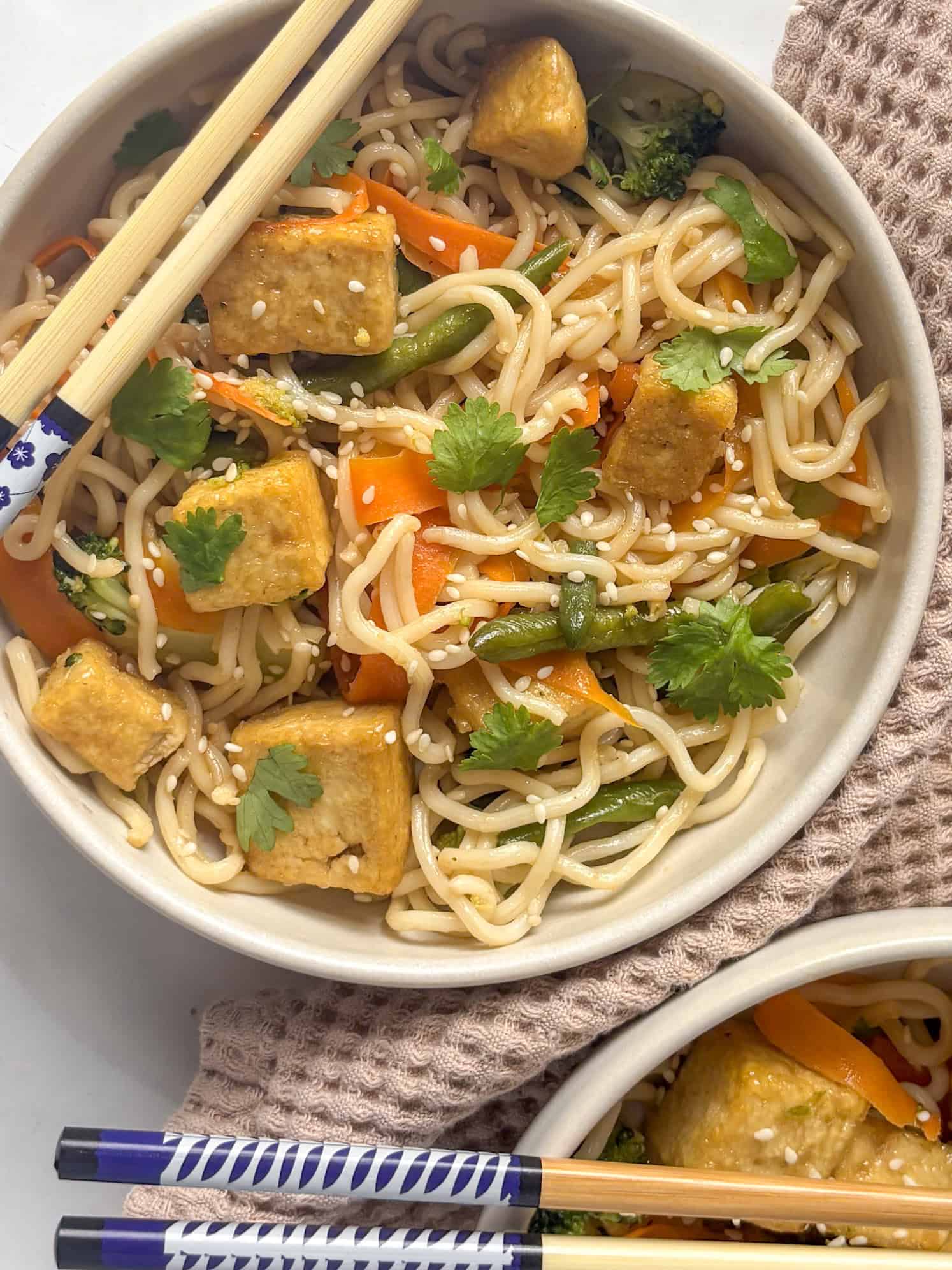 tofu stir fry noodles topped with sesame seeds