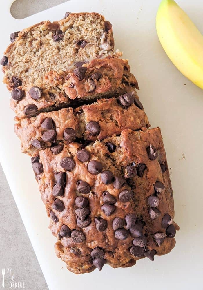 Chocolate chip banana loaf sliced on a cutting board.