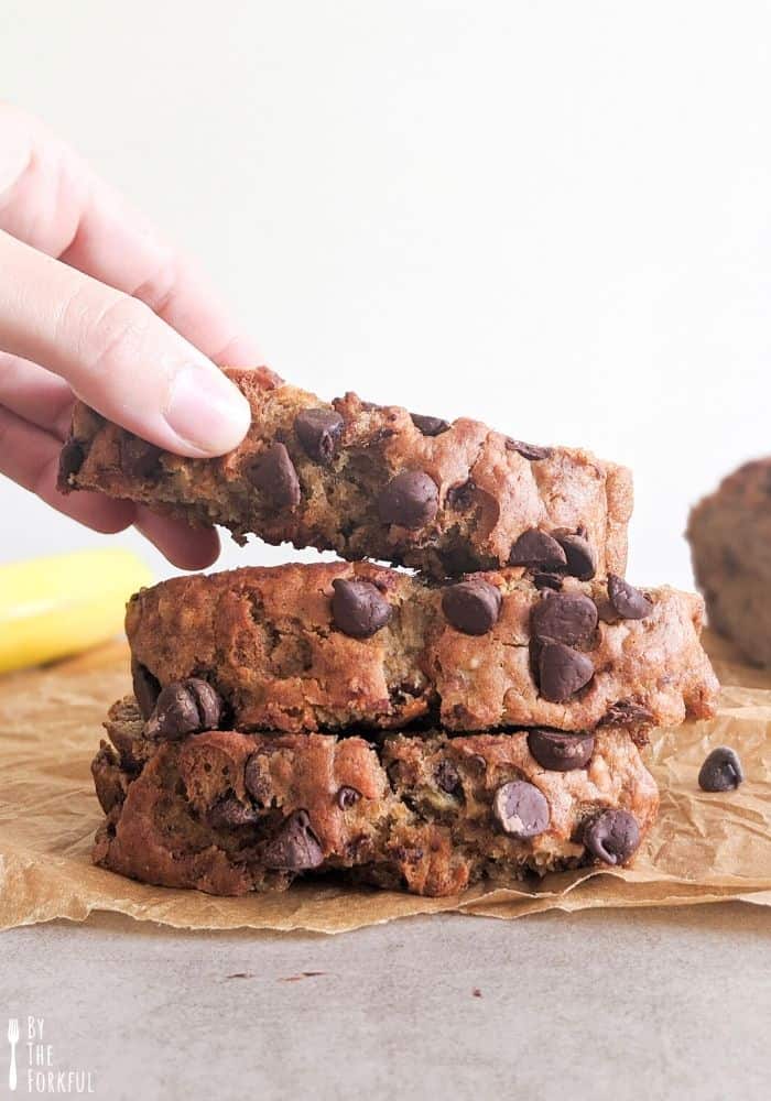 Slices of vegan chocolate chip banana bread stacked on top of each other.
