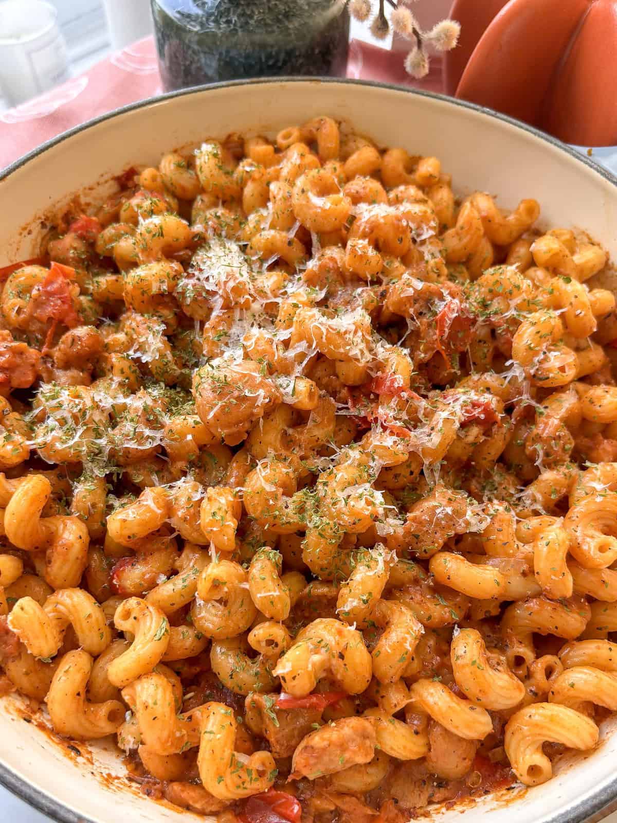 creamy sausage pasta with vegetarian sausages topped with cheese and parsley