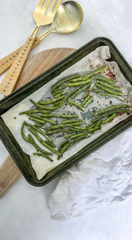 The finished product: tray of roasted frozen green beans with spices.