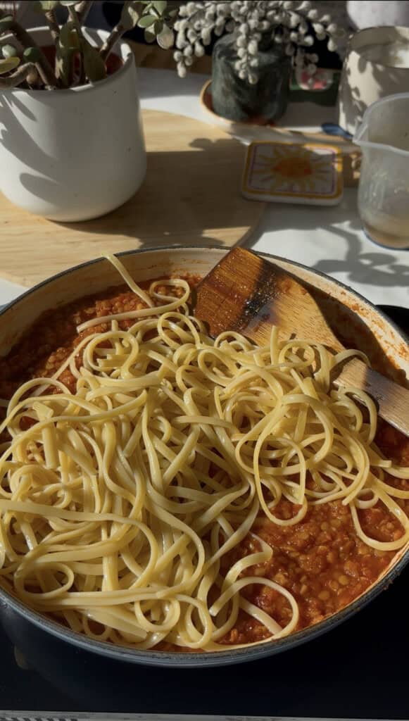 Cooked pasta stirred into the finished bolognese sauce