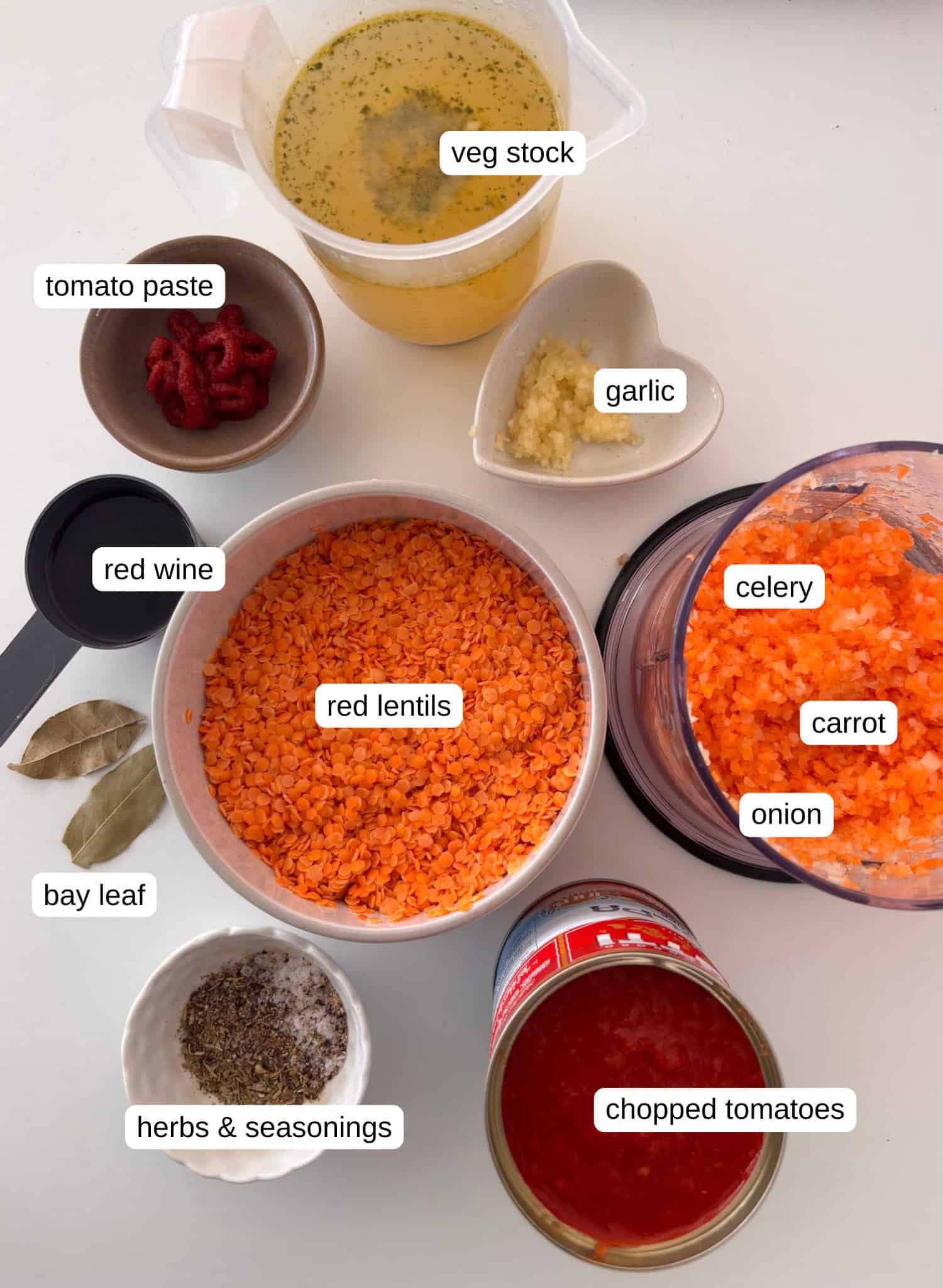 ingredients needed for lentil bolgonese: vegetable stock, tomato paste, garlic, celery, carrot, onion, red lentils, red wine, bay leaf, herbs, and chopped tomatoes