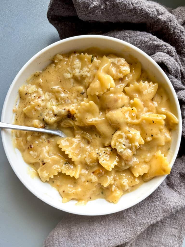 french onion pasta in a white bowl