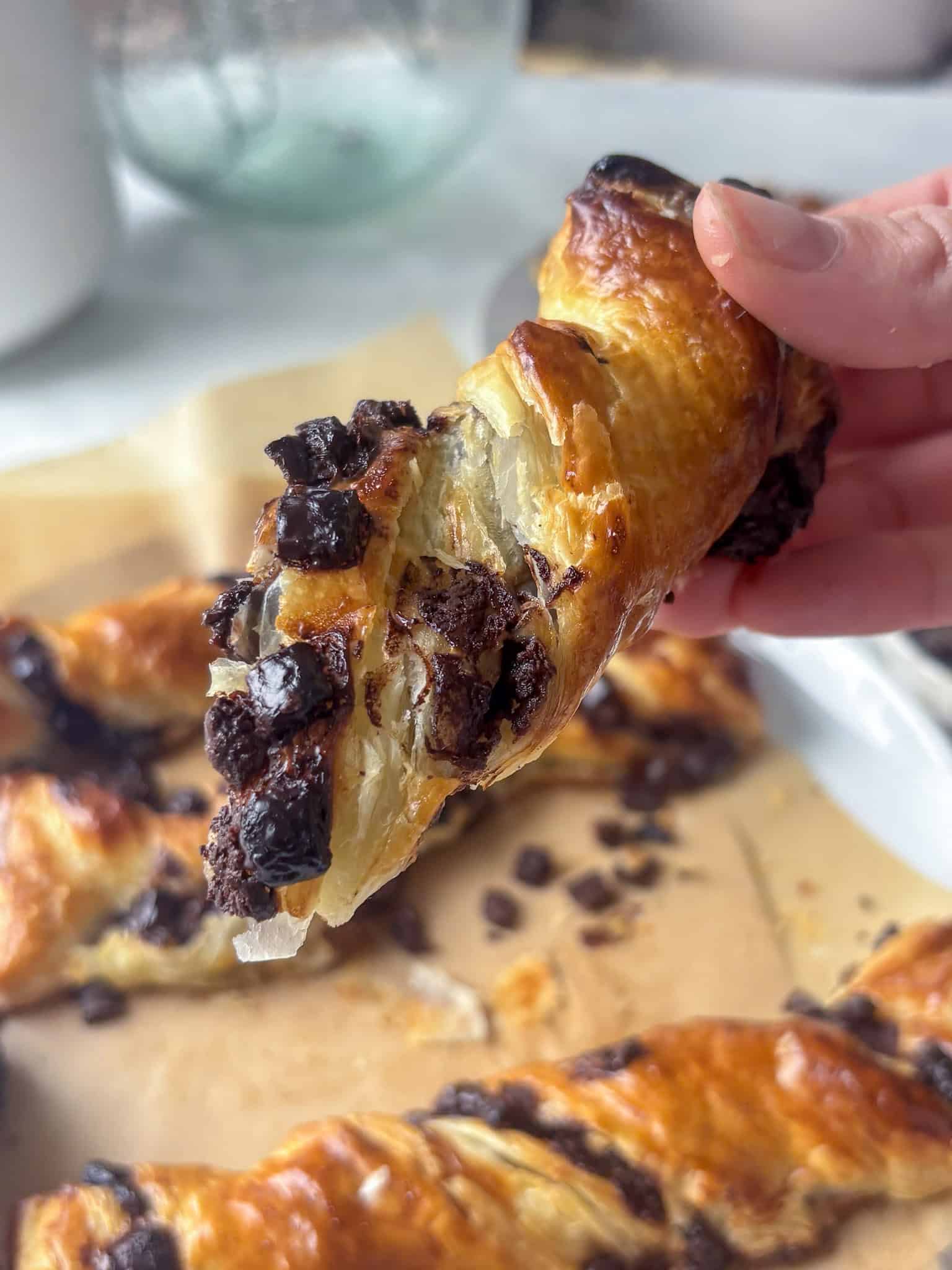 a close up shot of a half a chocolate twist, with the melty chocoalte interior on display