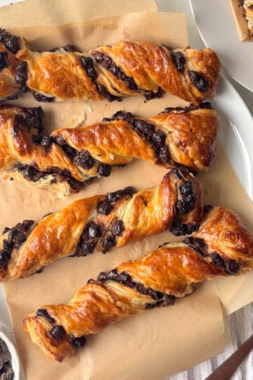 chocolate chips beside it and another plate of chocolate twists just in the corner of the shot