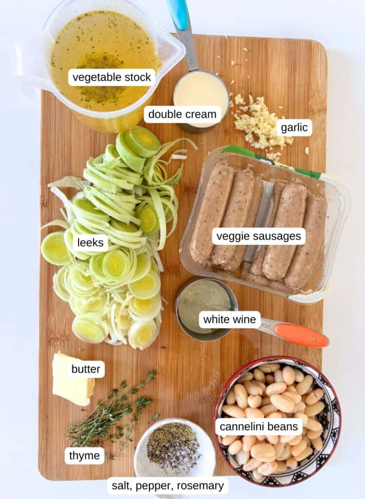 All the ingredients you'll need for this sausage and bean casserole recipe: vegetable stock, double cream, garlic, leeks, vegetarian sausages, white wine, butter, thyme, cannellini beans, rosemary, salt, pepper, pecorino cheese, and lemon