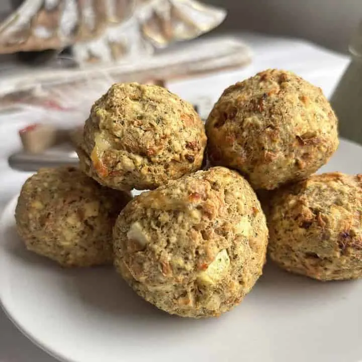 a stack of cooked vegetarian stuffing balls arrange on a white plate