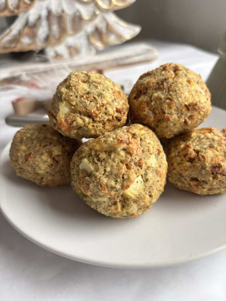 a stack of cooked vegetarian stuffing balls arrange on a white plate