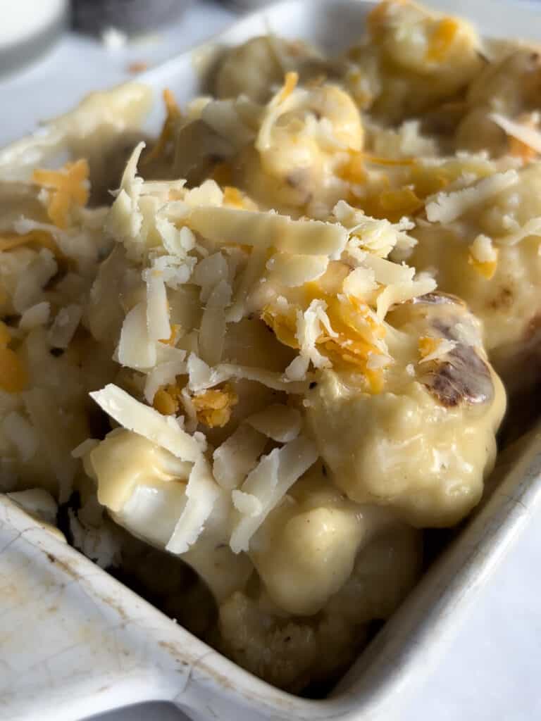 cauliflower cheese scattered with cheese, ready to be baked