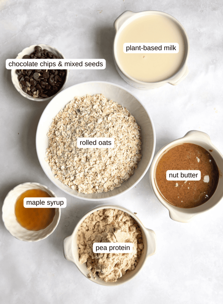 ingredients list for protein flapjacks: plant-based milk, chocolate chips and mixed seeds, rolled oats, pea protein powder, maple syrup, nut butter