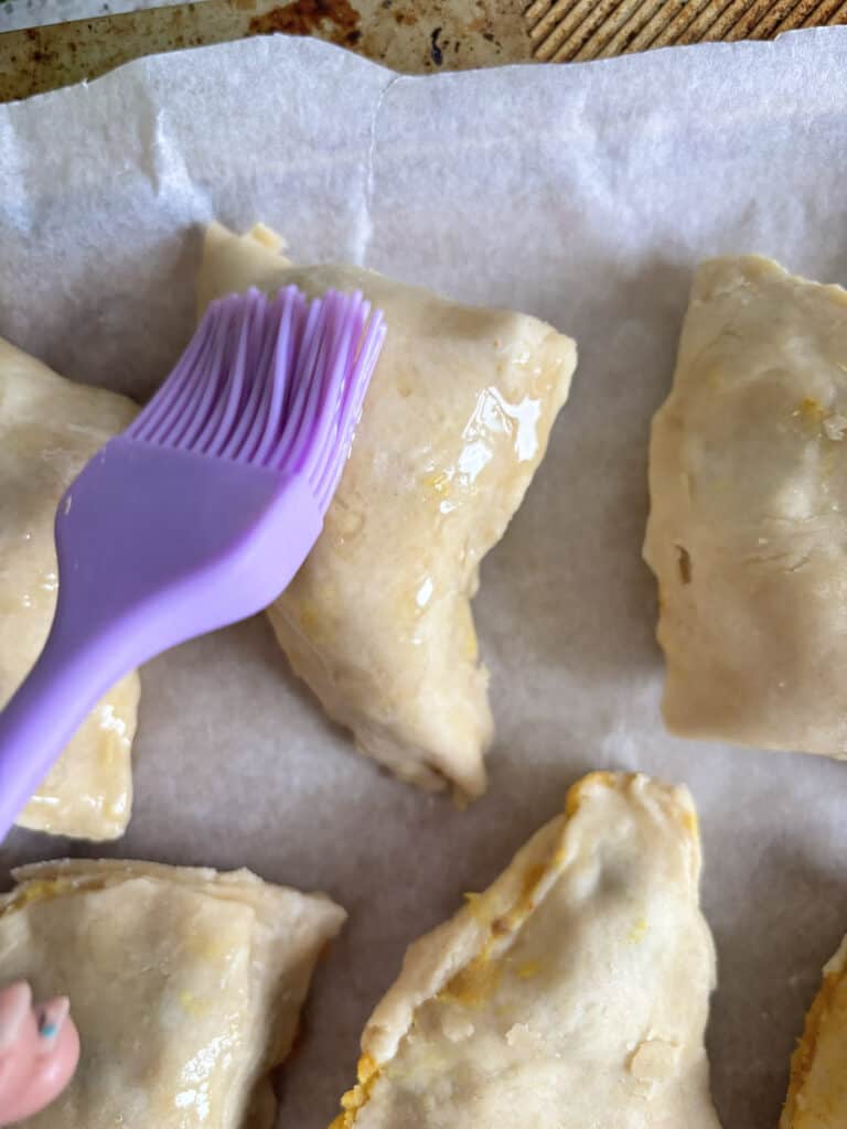 a close up of the samosa being brushed with oil