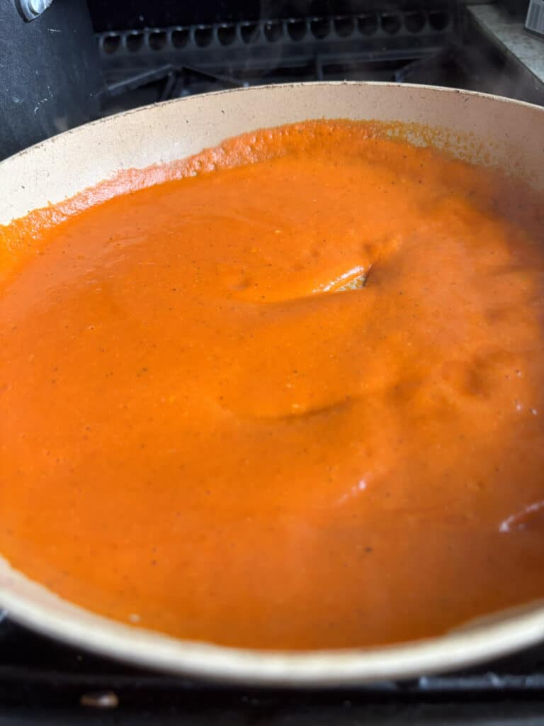 the roasted red pepper pasta sauce heating in a saucepan