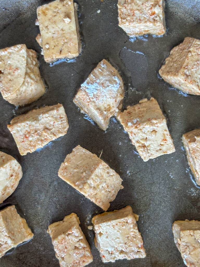 an overhead shot of tofu being fried in a saucepan