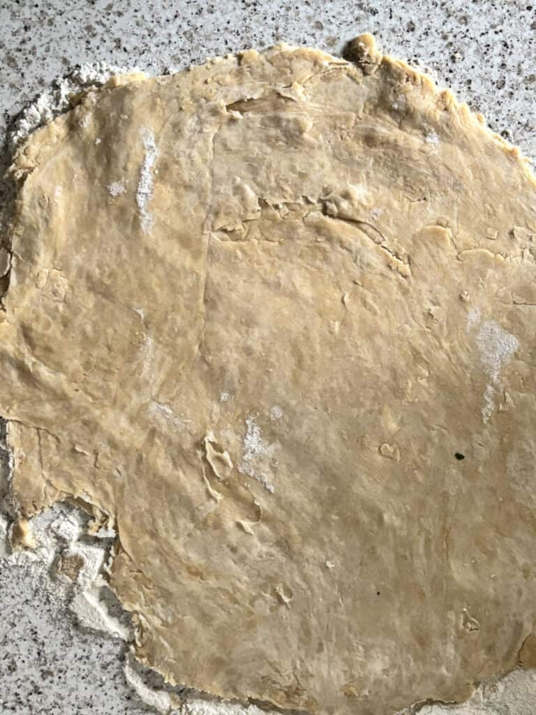 the samosa dough rolled out flat on a floured surface