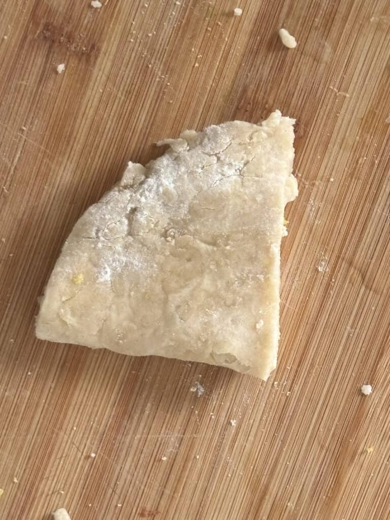 the samosa dough folded in half, so the straight edges meet to form a cone