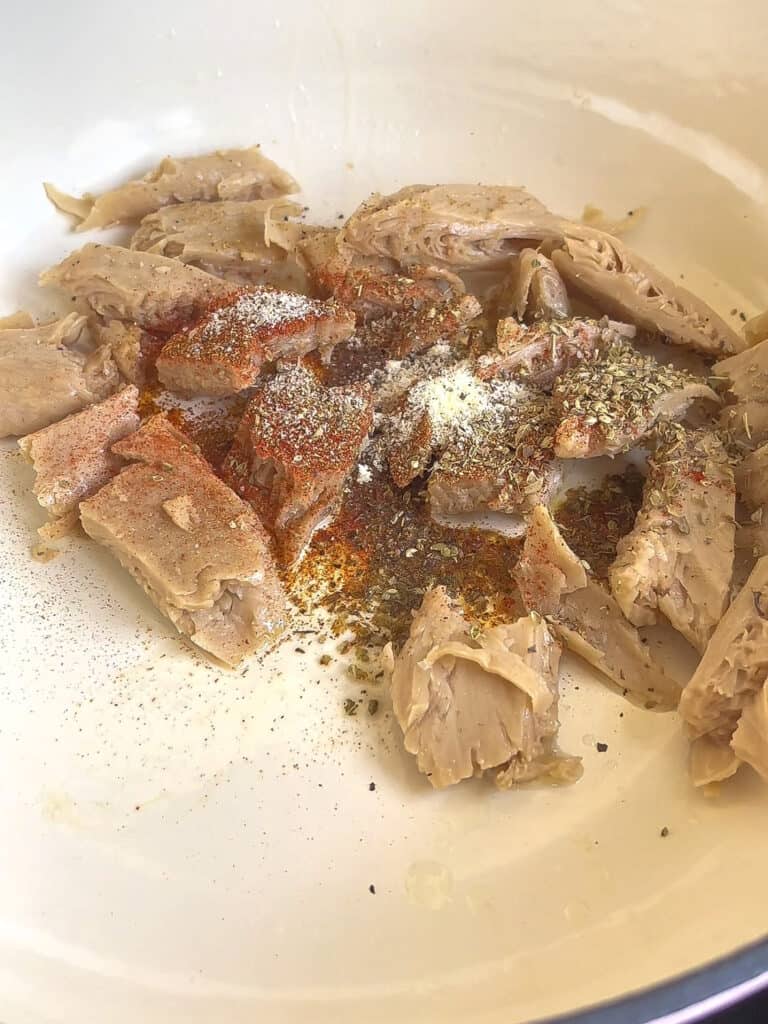 vegan chicken with seasonings in a pan