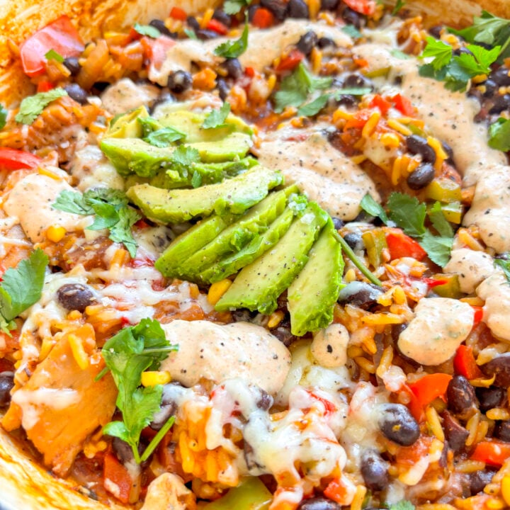a shot of the one pot vegetarian taco bowl topped with creamy jalapeno sauce and avocado
