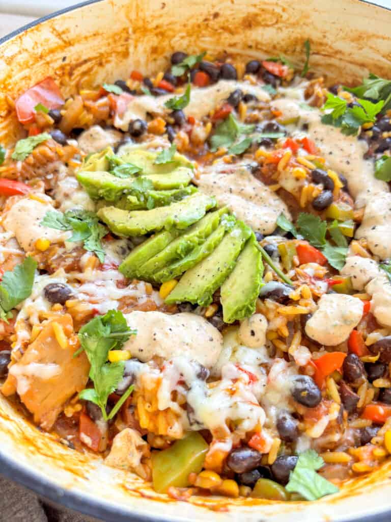 a shot of the one pot vegetarian taco bowl topped with creamy jalapeno sauce and avocado
