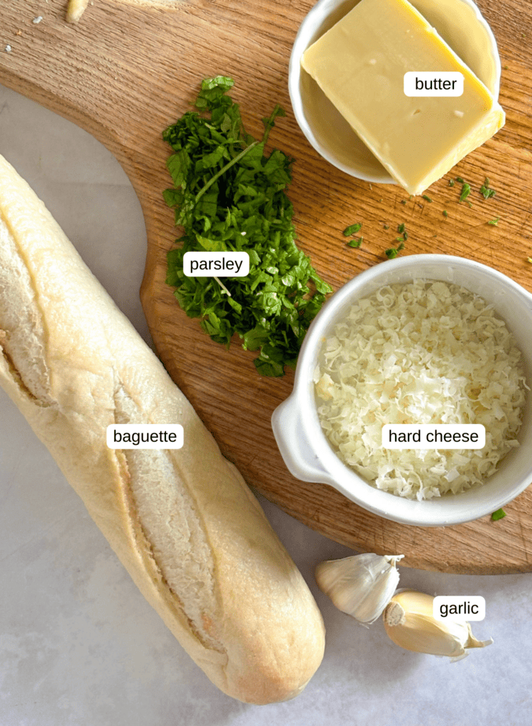 ingredients list for baguette garlic bread: shown in the photo is butter, parsley, hard cheese (Pecorino), and baguette