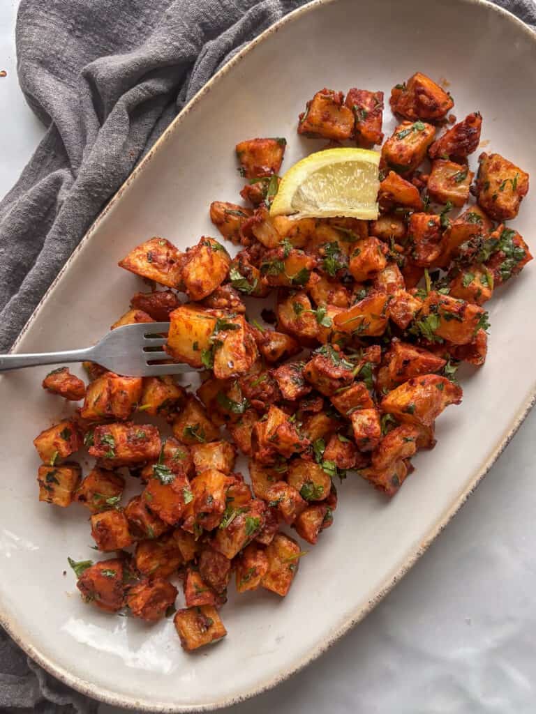 a serving platter of batata harra, spicy potatoes