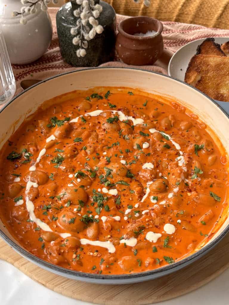 creamy beans alla vodka topped with red pepper flakes and parsley with a drizzle of cream