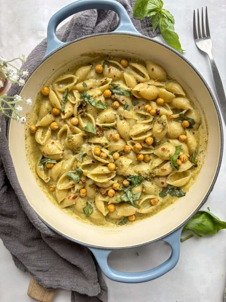 an overhead shot of creamy pesto alfredo in a casserole dish