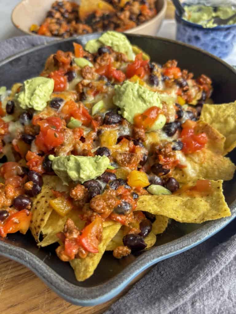 a close up shot of the finished loaded skillet nachos