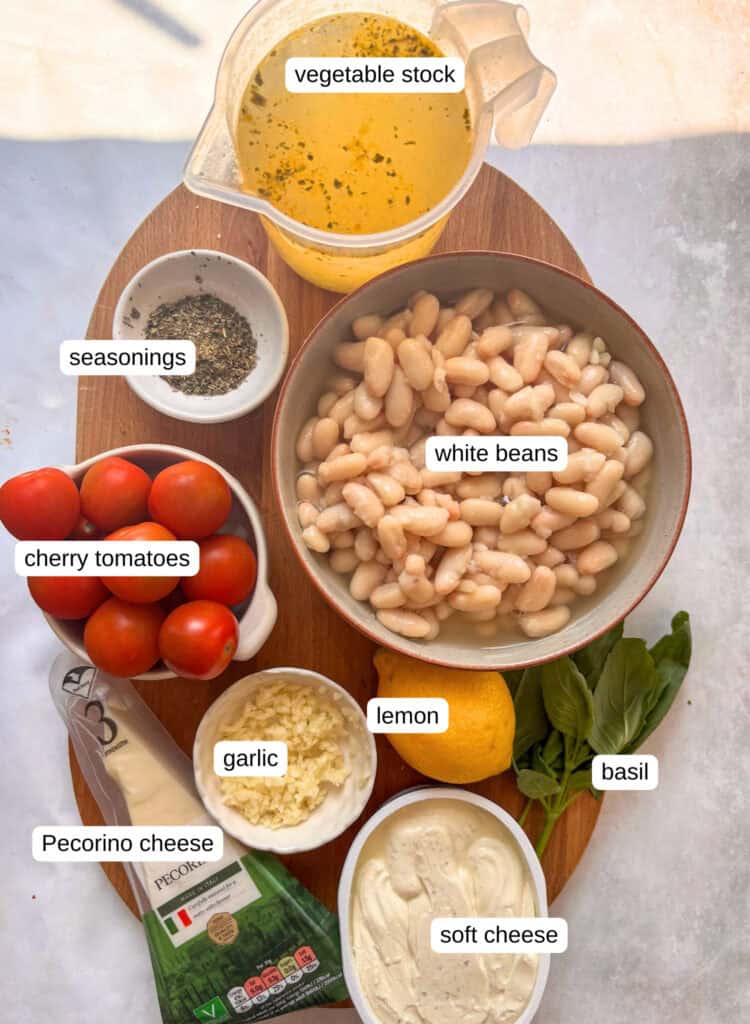 creamy white beans ingredient shot: veg stock, seasonings, white beans, cherry tomatoes, lemon, basil, garlic, cheese, and soft cheese