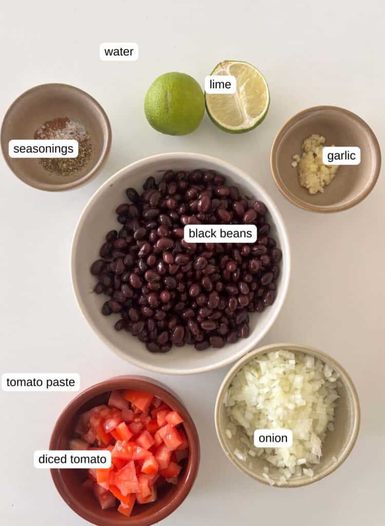 ingredients photo for Mexican black beans: lime, garlic, seasonings, black beans, onion, tomatoes