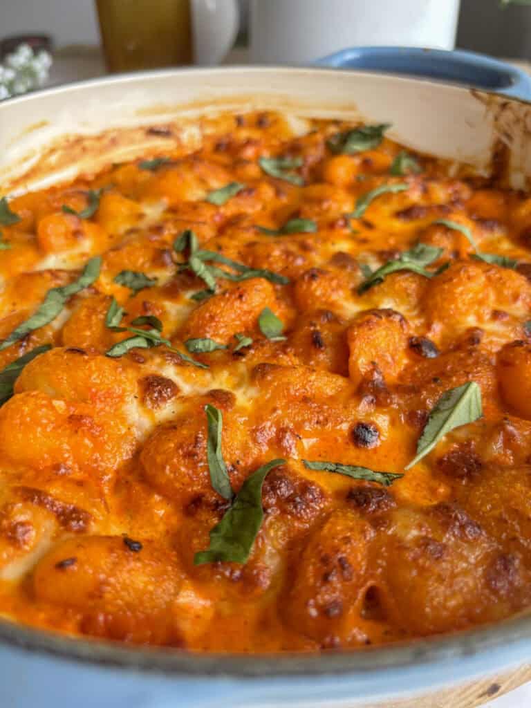 crispy and golden red pesto gnocchi with grilled mozzarella and fresh basil on top