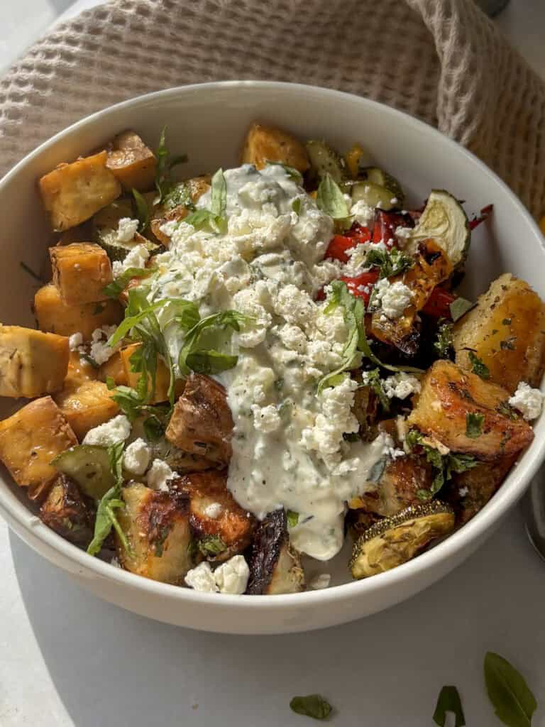 another view of the Greek tofu bowl with tzatziki and crumbled feta with shredded basil on top
