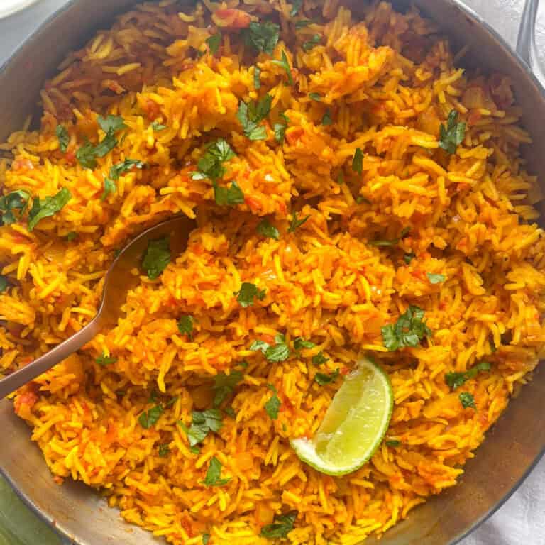 a pan of homemade nando's spicy rice topped with fresh herbs