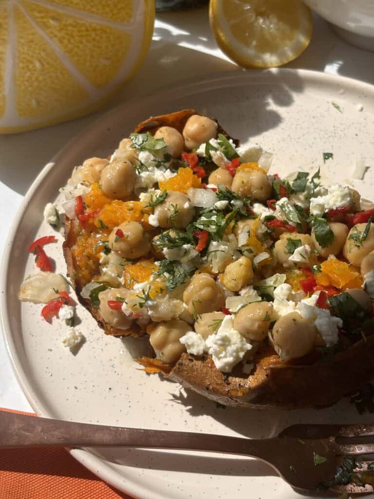 Loaded Greek stuffed sweet potato with chickpeas, feta, and herbs