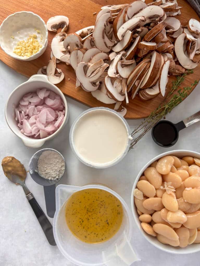 butter bean and mushroom stroganoff ingredient shot: butter beans, stock, mustard, flour, creme fraiche, thyme, balsamic vinegar, mushrooms, shallots, garlic