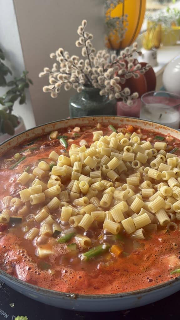 after simmering, ditalini pasta is added to the soup