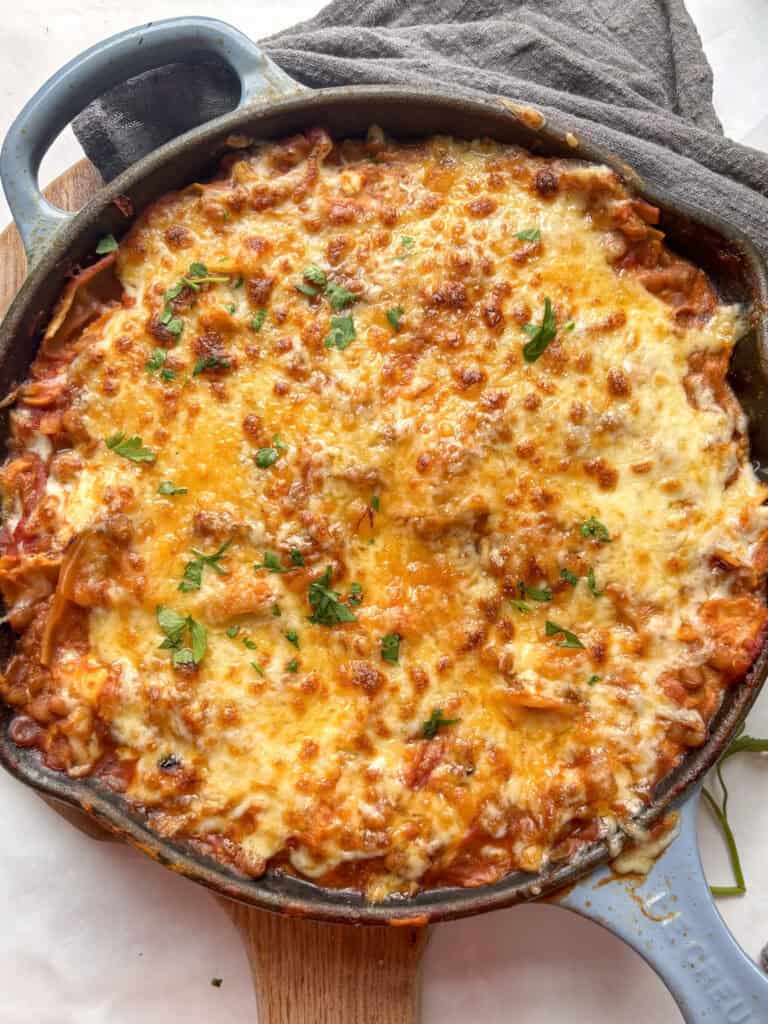 a golden and bubbly one-pot skillet vegetarian lasanaga topped with melty mozzarella and fresh herbs