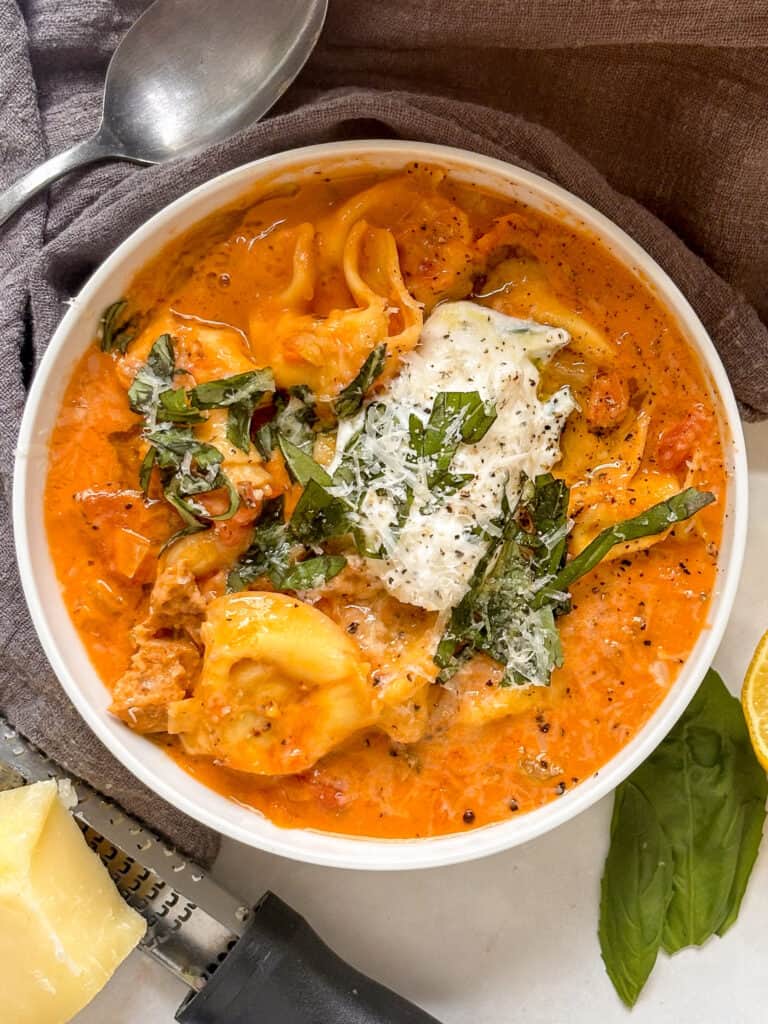 creamy tortellini soup with cheese tortellini, white beans, crumbled sausage,in a creamy tomato sauce topped with ricotta and basil