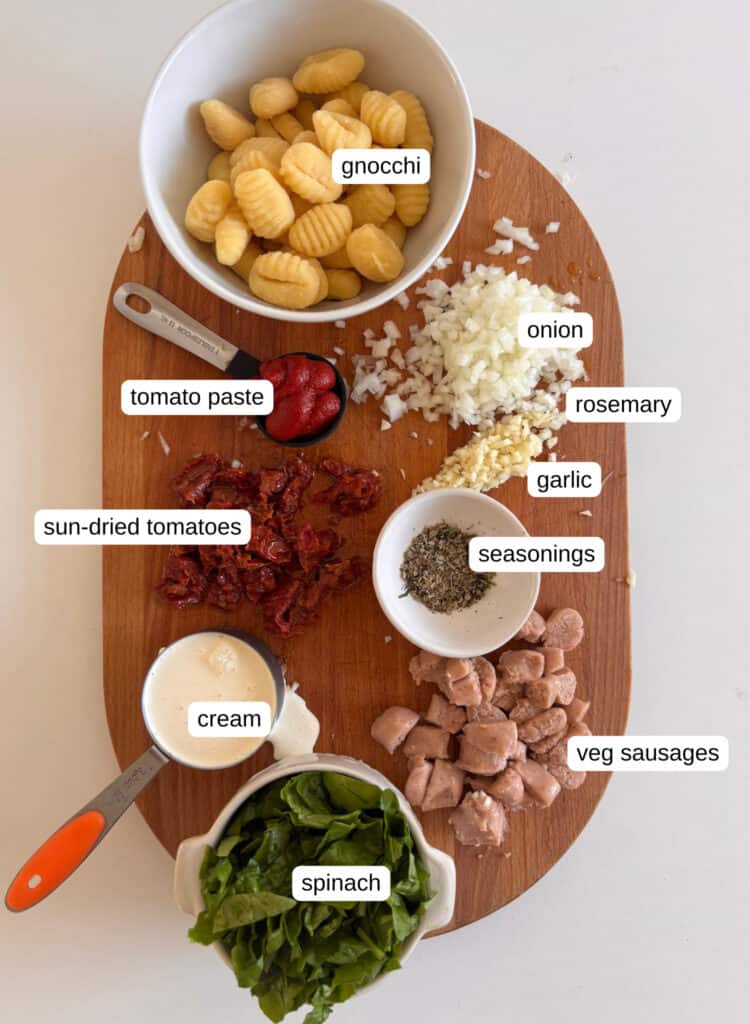 ingredient shot for creamy sausage gnocchi - gnocchi, onion, tomato paste, garlic, seasonings, sun-dried tomatoes, cream, vegetarian sausages, cream