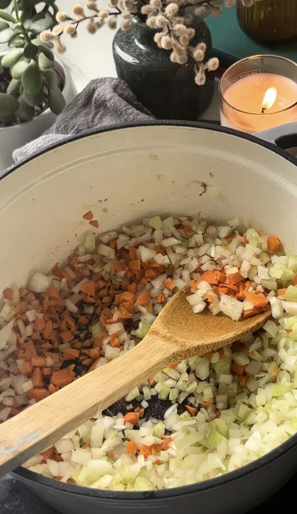 sofrito of onion, carrot, and celery being sauted in the same pan