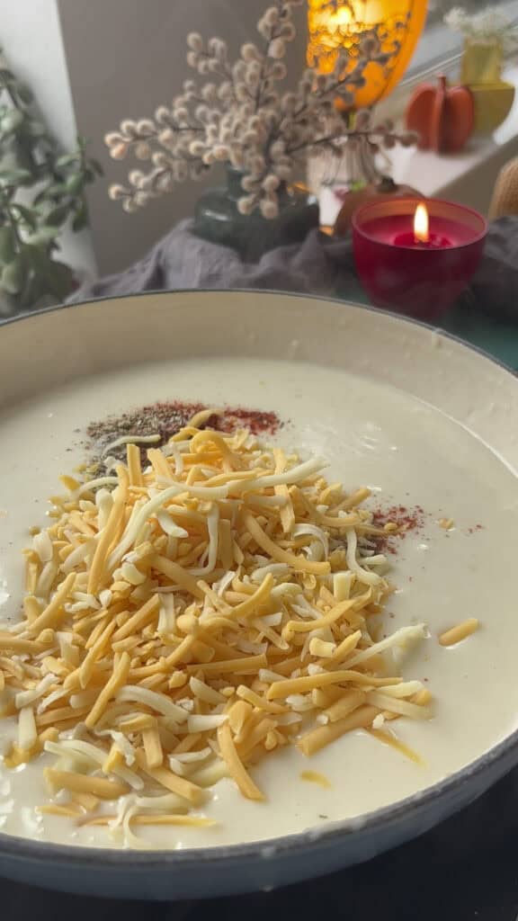 cheese and seasonings are added to the mac and cheese sauce