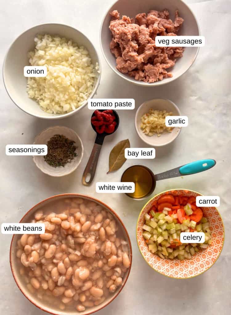 sausage kale and white bean soup ingredients: vegetarian sausages, white beans, stock, celery, carroy, onion, bay leaf, white wine, seasonings, tomato paste, garlic