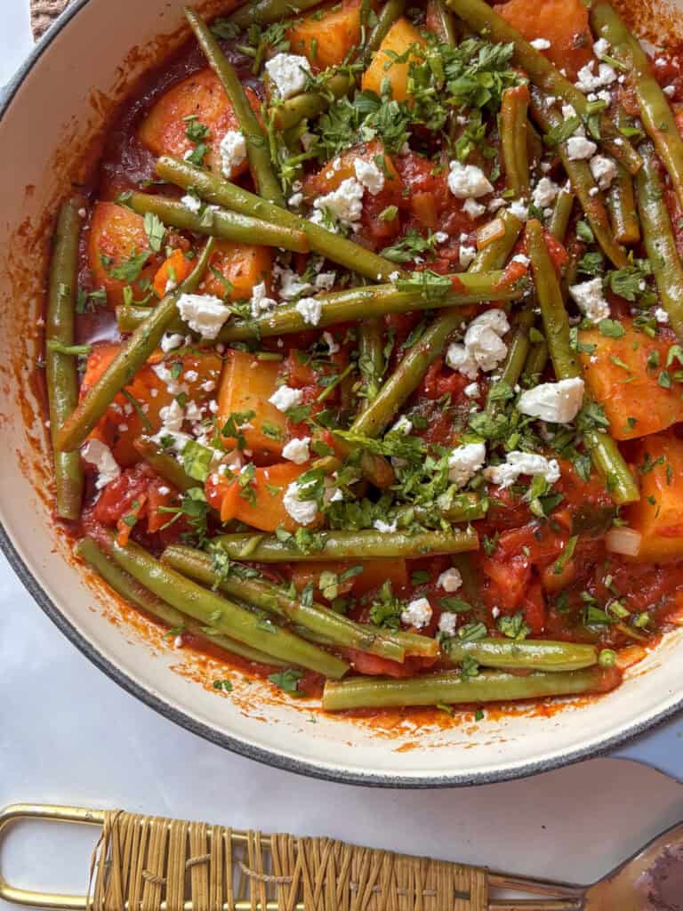 greek green beans - fasolakia - in a casserole pan. Potatoes and green beans simmered in a tomato sauce