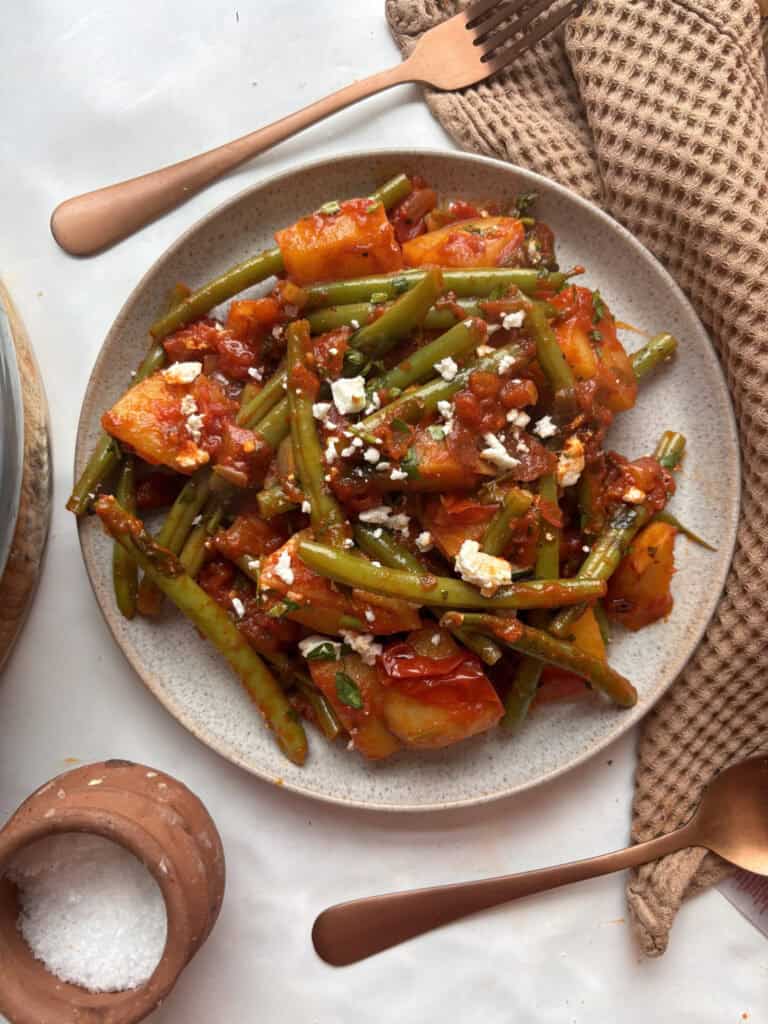 greek green beans - fasolakia - in a casserole pan. Potatoes and green beans simmered in a tomato sauce