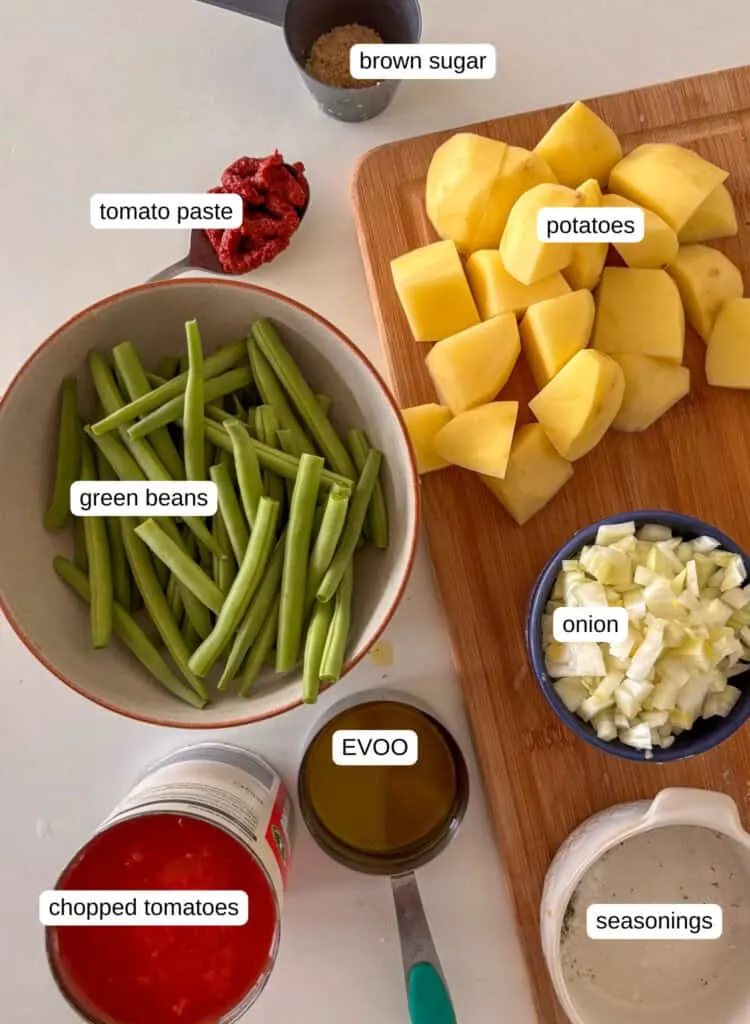 ingredients needs for fasolakia (greek green beans) - brown sugar, potatoes, tomato paste, green beans, onion, EVOO, seasonings, chopped tomatoes