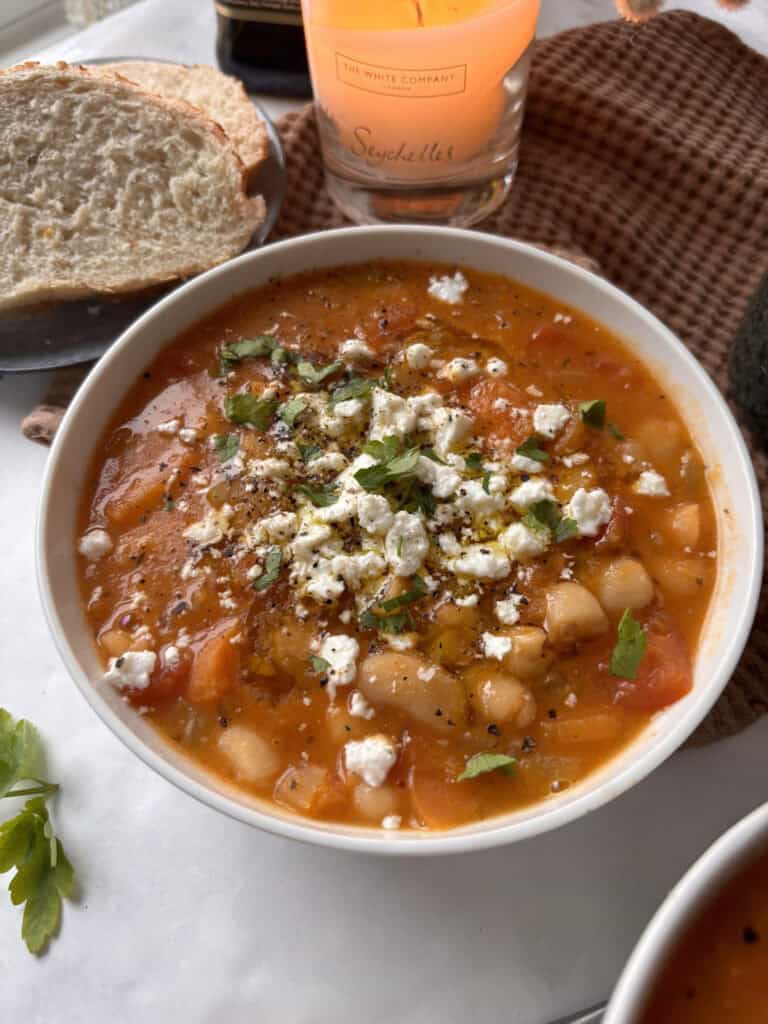 greek bean soup topped with crumbled feta, parsley, and olive oil