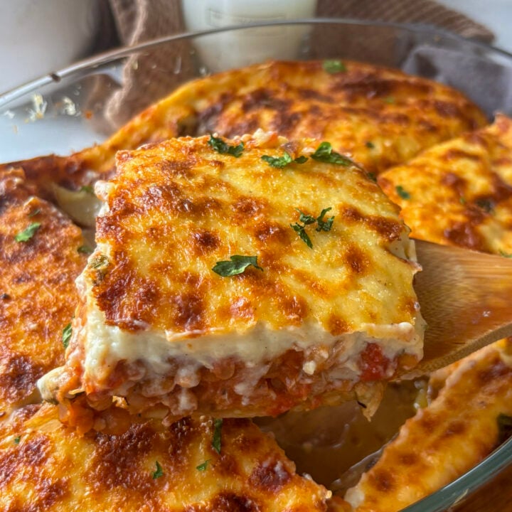 a slice of vegetarian moussaka being lifted out of the pan